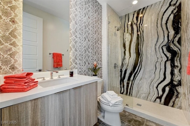 bathroom with a stall shower, vanity, and toilet