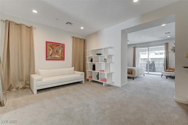 sitting room with baseboards, recessed lighting, visible vents, and light colored carpet