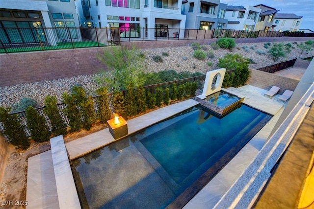 view of pool featuring an in ground hot tub, fence, and a residential view