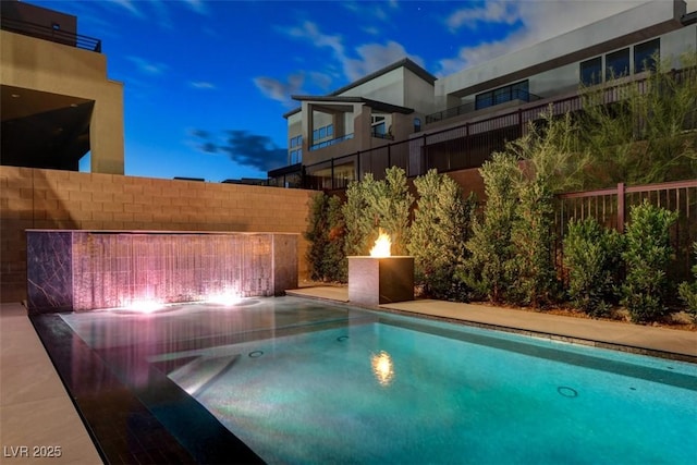 view of swimming pool featuring fence