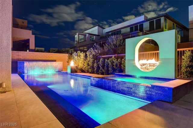 view of swimming pool with an in ground hot tub, a patio, fence, and a fenced in pool