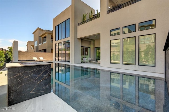 view of swimming pool featuring a patio area, a fenced in pool, fence, and an outdoor bar