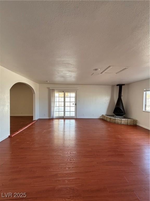 unfurnished living room with dark hardwood / wood-style floors and a textured ceiling