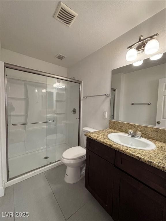 bathroom with walk in shower, vanity, toilet, and tile patterned flooring