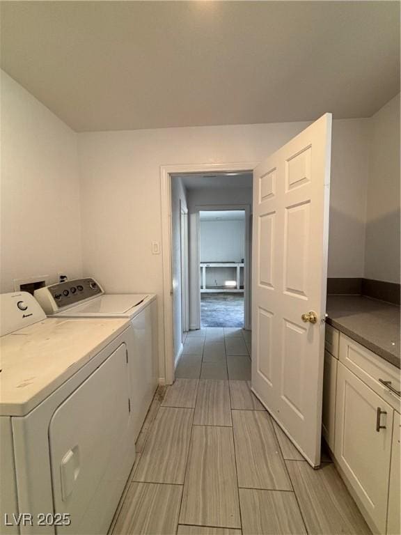 laundry area with cabinets and independent washer and dryer