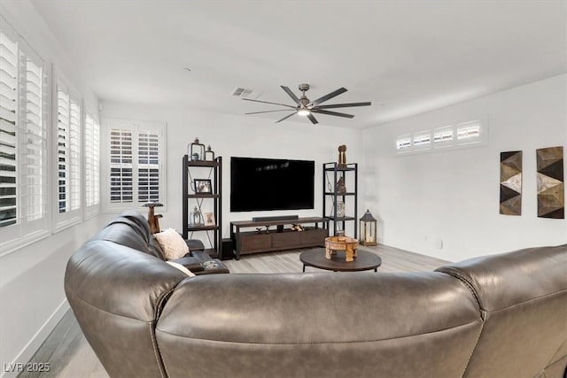 living room featuring light hardwood / wood-style flooring and ceiling fan