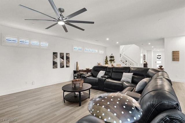 living room featuring ceiling fan and light hardwood / wood-style flooring