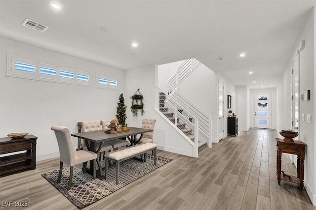 dining space with light hardwood / wood-style flooring