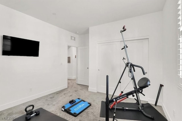 exercise room with light colored carpet