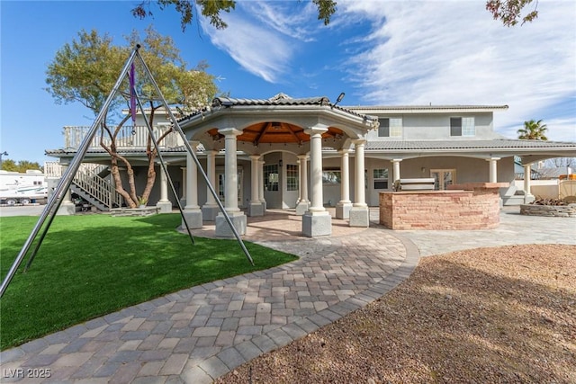 back of house featuring a yard and a patio area