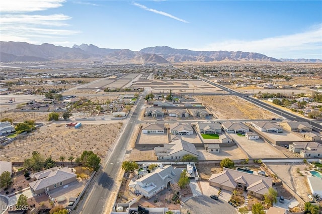 birds eye view of property with a mountain view