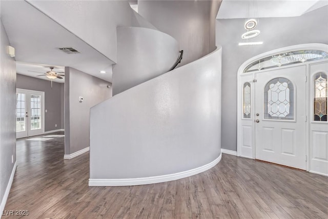 entrance foyer featuring hardwood / wood-style floors, ceiling fan, and french doors