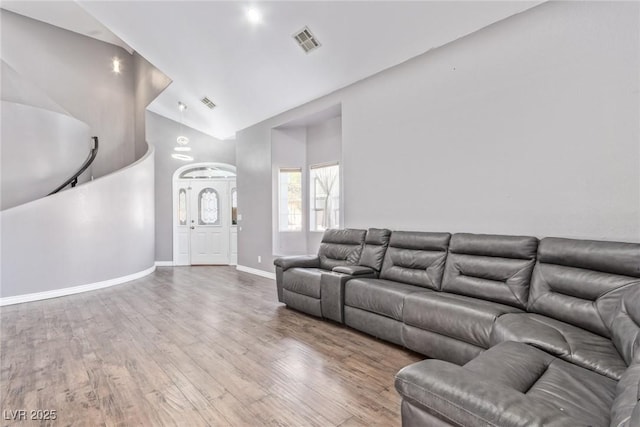 living room featuring hardwood / wood-style flooring and vaulted ceiling