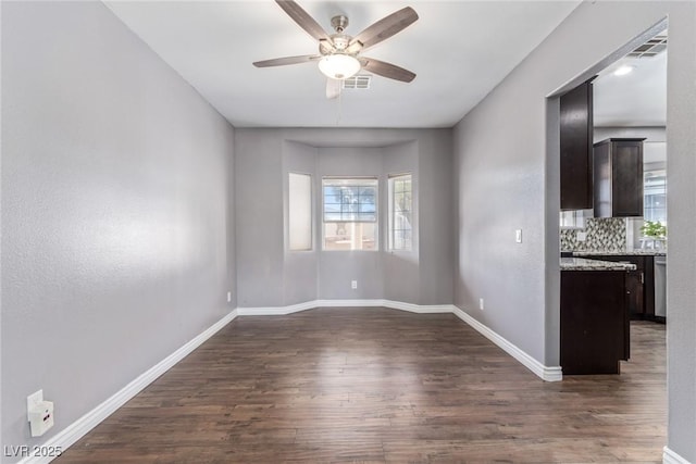 interior space with dark wood-type flooring and ceiling fan