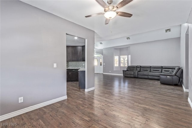 unfurnished living room with dark hardwood / wood-style floors and ceiling fan