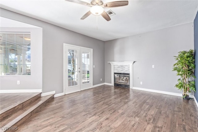 unfurnished living room with hardwood / wood-style floors, french doors, and ceiling fan