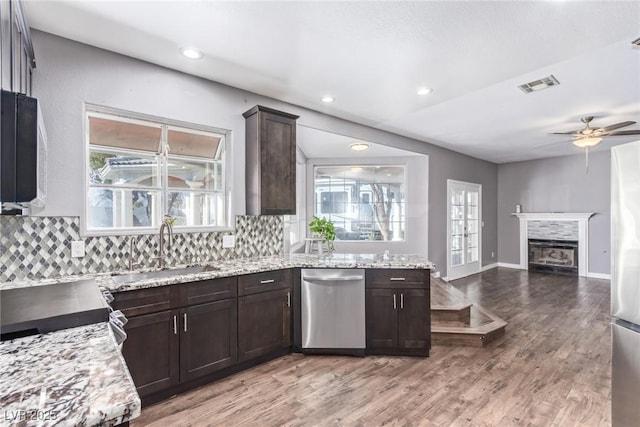 kitchen featuring tasteful backsplash, appliances with stainless steel finishes, sink, and wood-type flooring