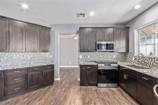 kitchen featuring sink, dark brown cabinets, and appliances with stainless steel finishes