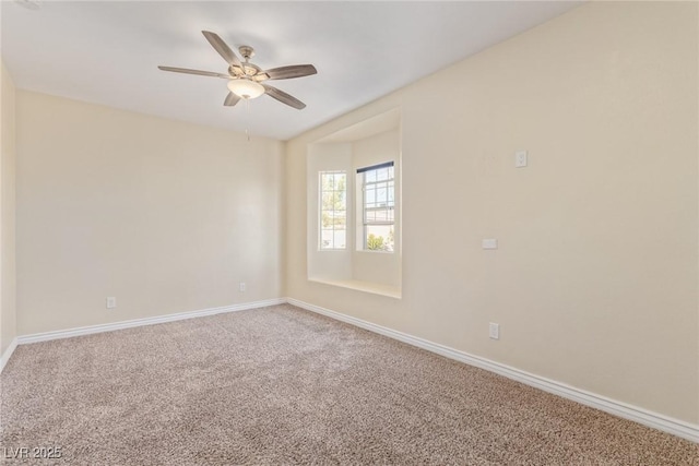 carpeted spare room with ceiling fan