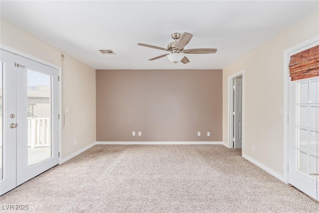 spare room featuring light colored carpet and ceiling fan