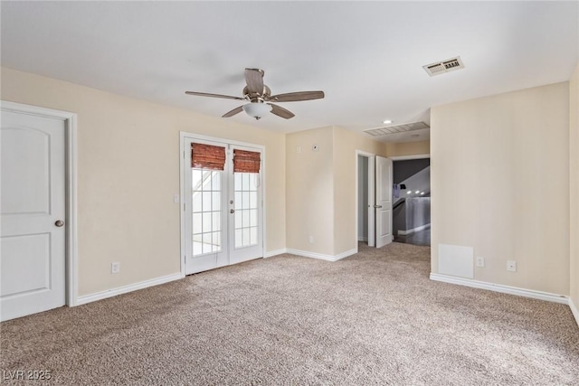 carpeted empty room featuring ceiling fan and french doors