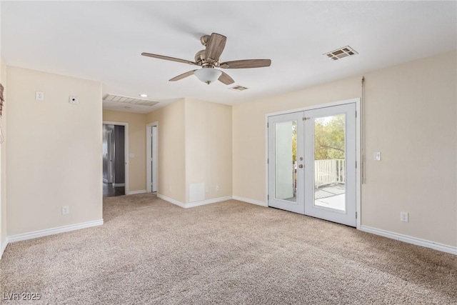 spare room featuring light colored carpet, french doors, and ceiling fan