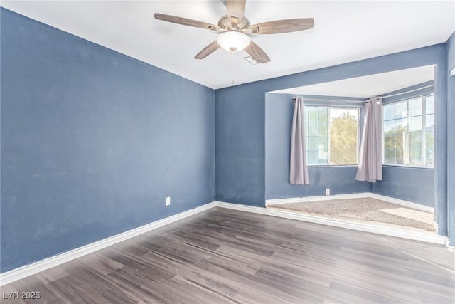 empty room with wood-type flooring and ceiling fan