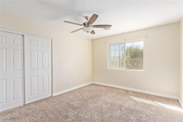 unfurnished bedroom featuring carpet flooring, ceiling fan, and a closet