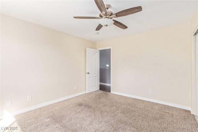 empty room with ceiling fan and carpet flooring