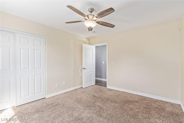 unfurnished bedroom with ceiling fan, carpet flooring, and a closet