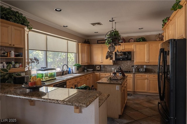 kitchen featuring tasteful backsplash, crown molding, a kitchen island, and black appliances