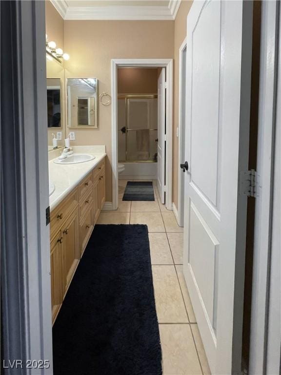 bathroom featuring crown molding, toilet, tile patterned floors, and vanity