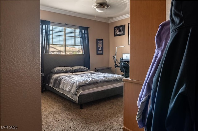 carpeted bedroom featuring crown molding and ceiling fan