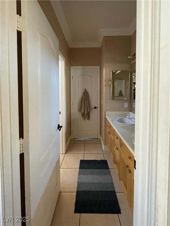 bathroom featuring vanity, tile patterned flooring, and crown molding