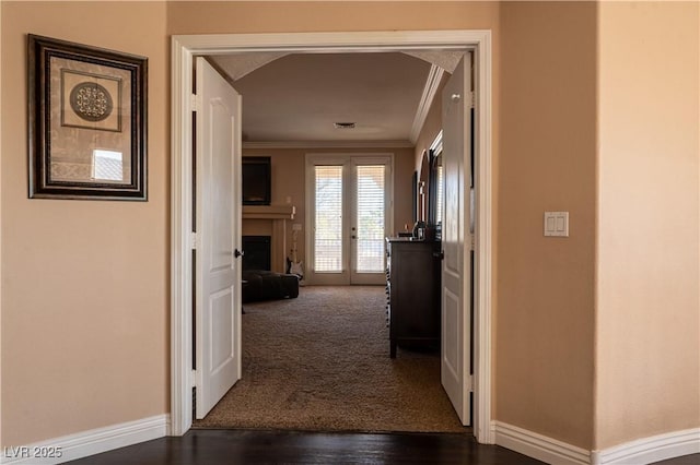 hall with ornamental molding and dark hardwood / wood-style floors