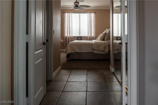 bedroom with ceiling fan and ornamental molding