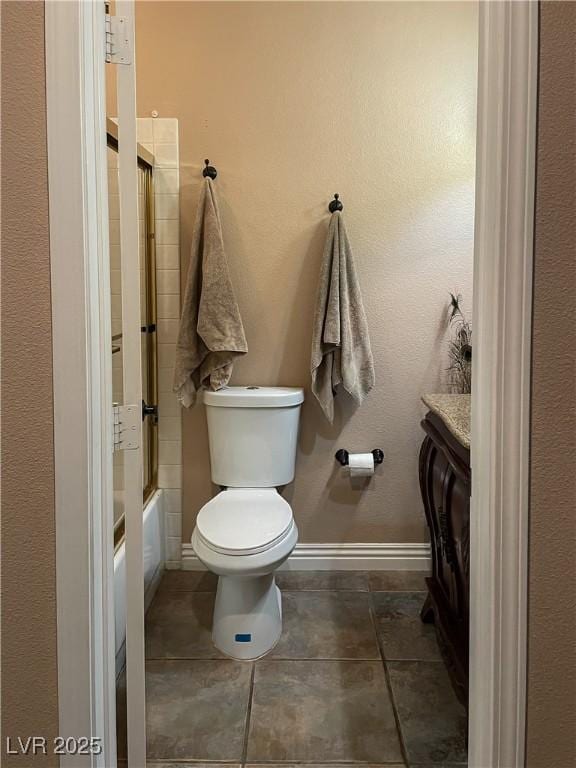 full bathroom with vanity, tile patterned flooring, shower / bath combination with glass door, and toilet