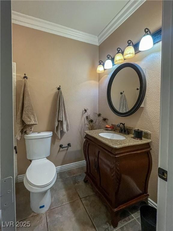 bathroom featuring vanity, tile patterned flooring, ornamental molding, and toilet