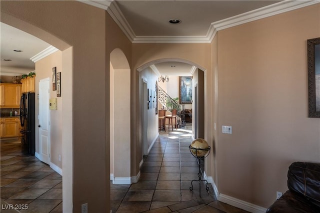 hallway with crown molding and dark tile patterned floors