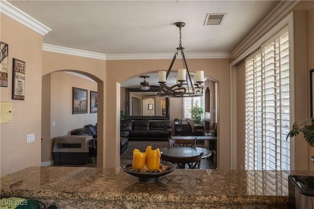 kitchen featuring ornamental molding, an inviting chandelier, and decorative light fixtures