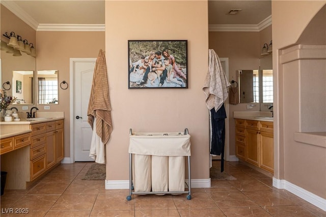 bathroom with ornamental molding, a wealth of natural light, and vanity