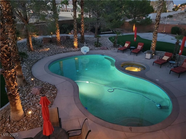 view of swimming pool featuring an in ground hot tub and a patio area