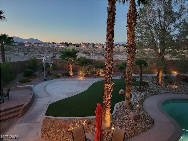 view of community with a mountain view, a swimming pool, and a patio area