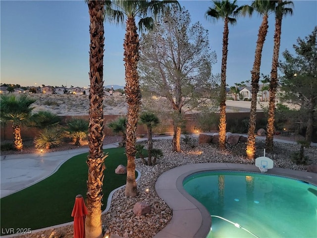 view of pool at dusk