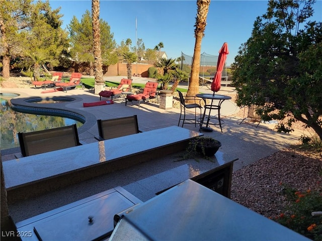 view of patio featuring an outdoor living space and an in ground hot tub