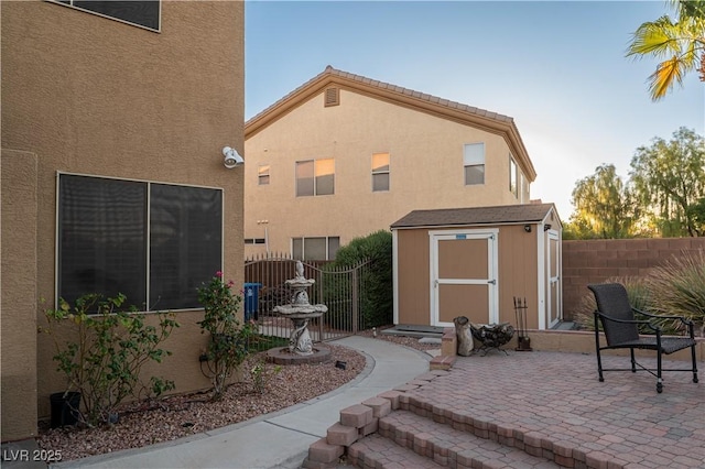 exterior space featuring a patio area and a storage unit