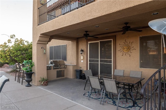 view of patio / terrace with a balcony, area for grilling, and ceiling fan