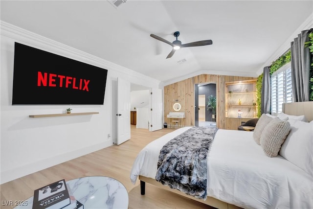 bedroom with hardwood / wood-style floors, ceiling fan, lofted ceiling, and crown molding