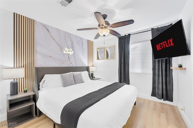 bedroom featuring ceiling fan and light hardwood / wood-style flooring