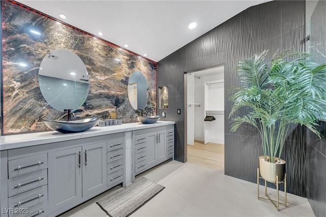 bathroom with vanity and lofted ceiling